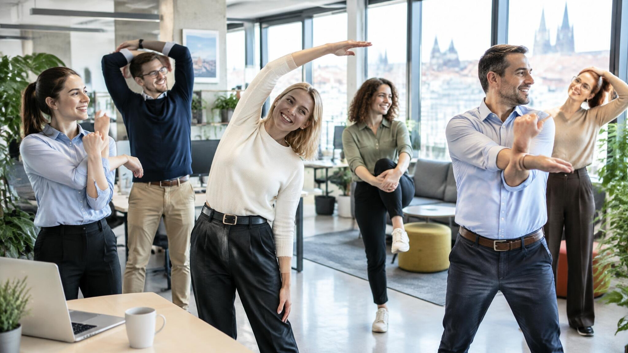 Employees stretching together during an office wellness break